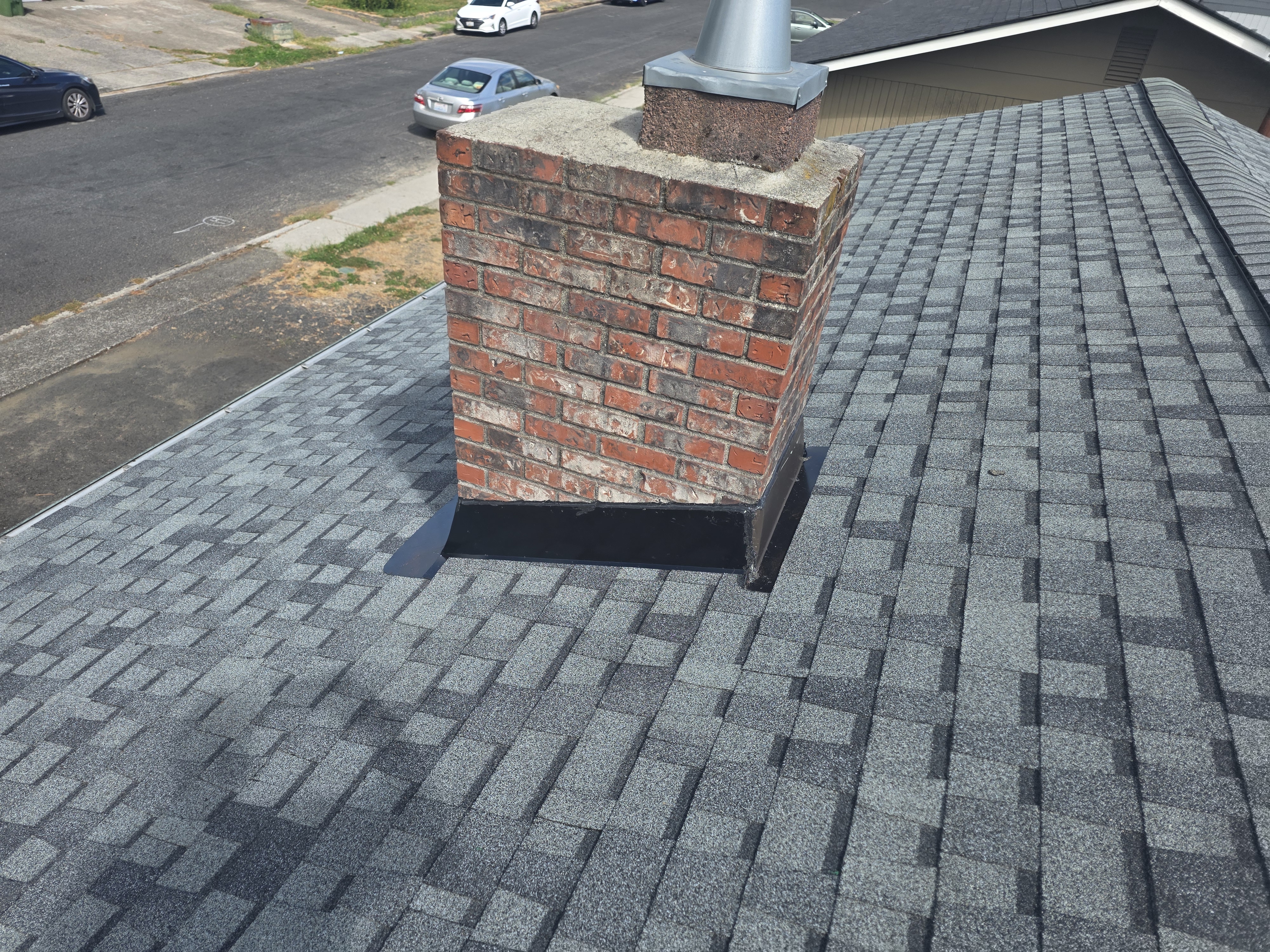 New architectural shingles and chimney flashing after a full reroof